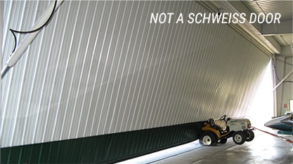 Not a Schweiss Door almost destroys plane